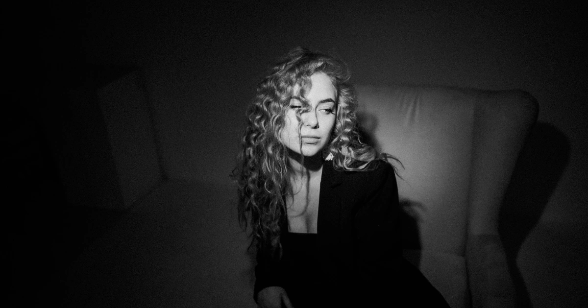 Girl sitting in the dark.