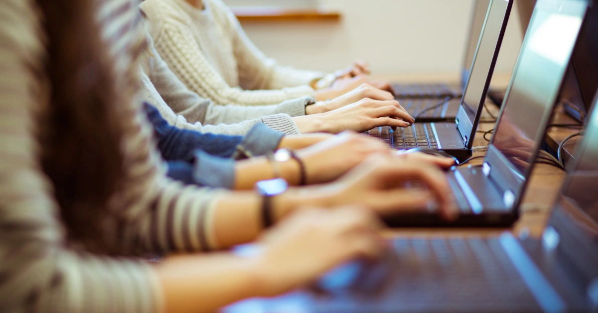 A row of people on laptops