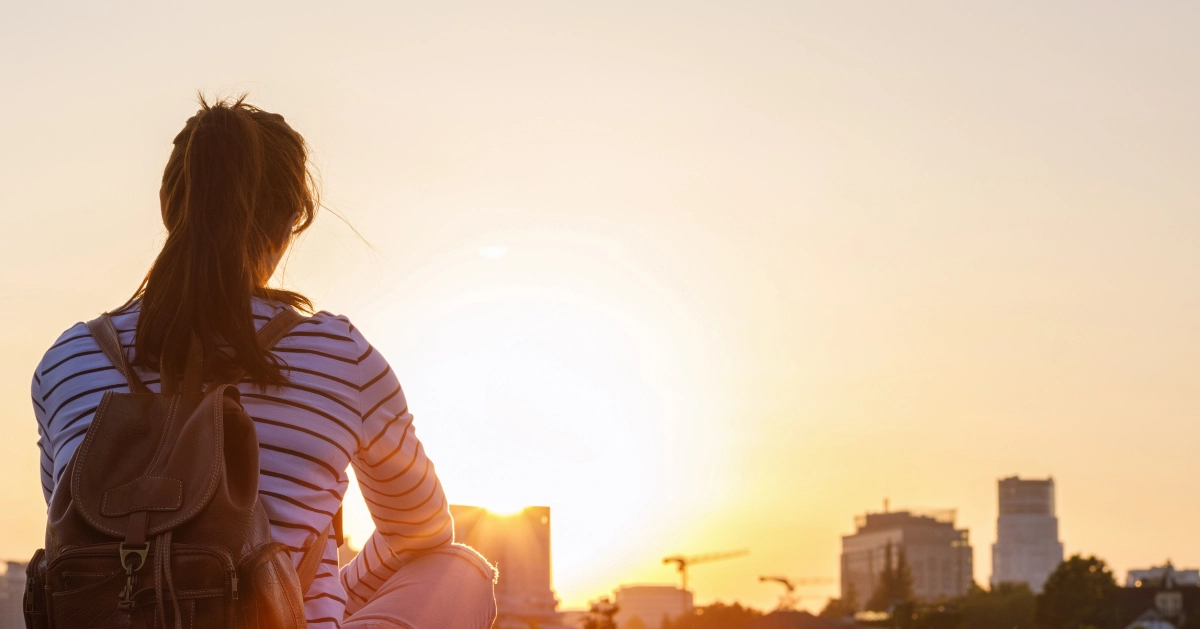 A girl sitting watching the sunset