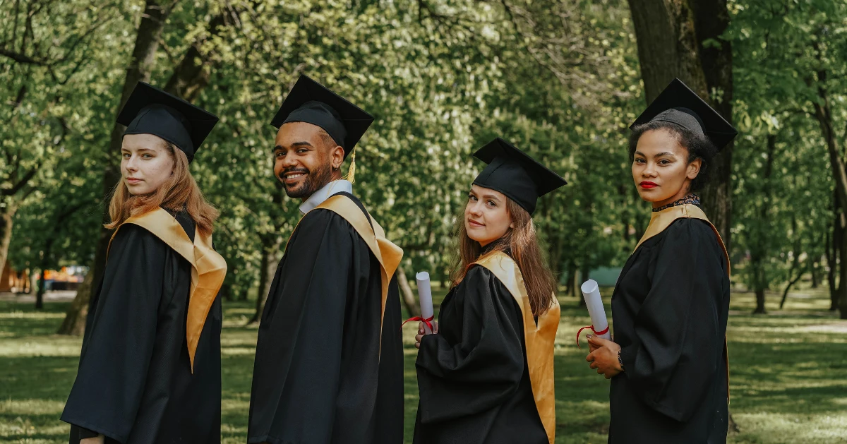 High school graduates posing outside.