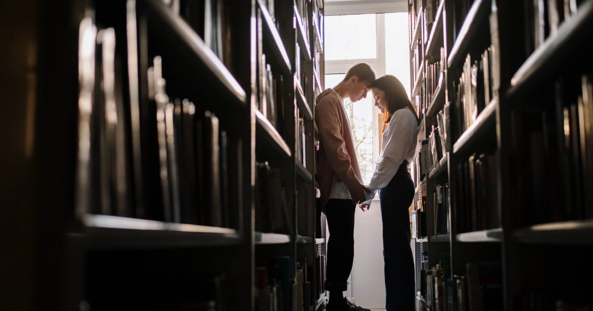 Couple holding hands in the library