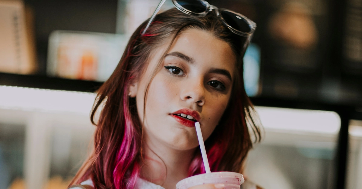 Girl drinking a smoothie.