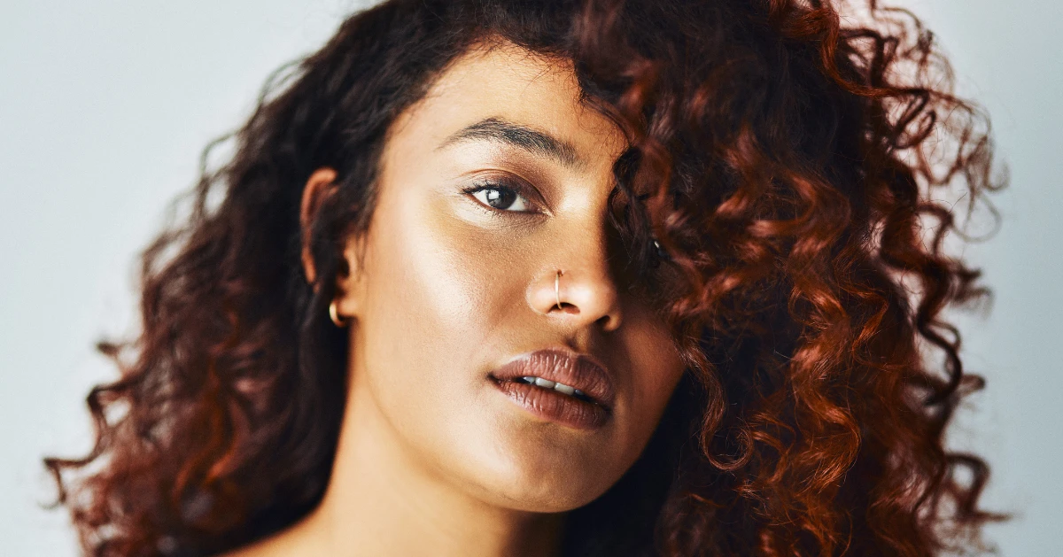 a young lady with red curly hair