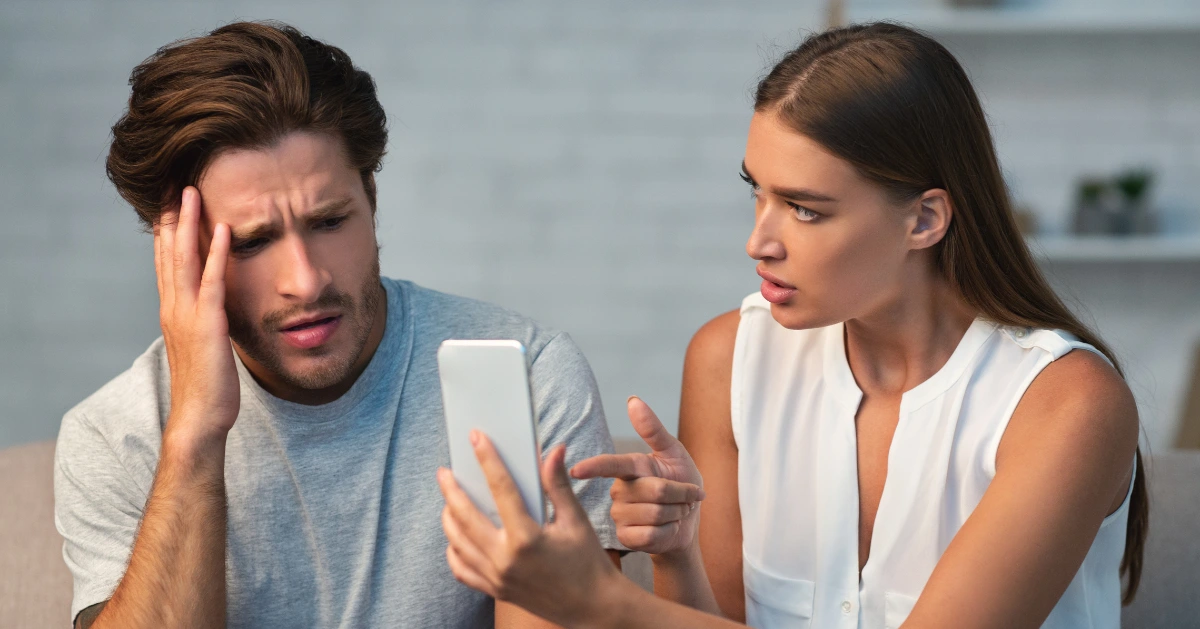 the girlfriend confronting her boyfriend cheating on his phone