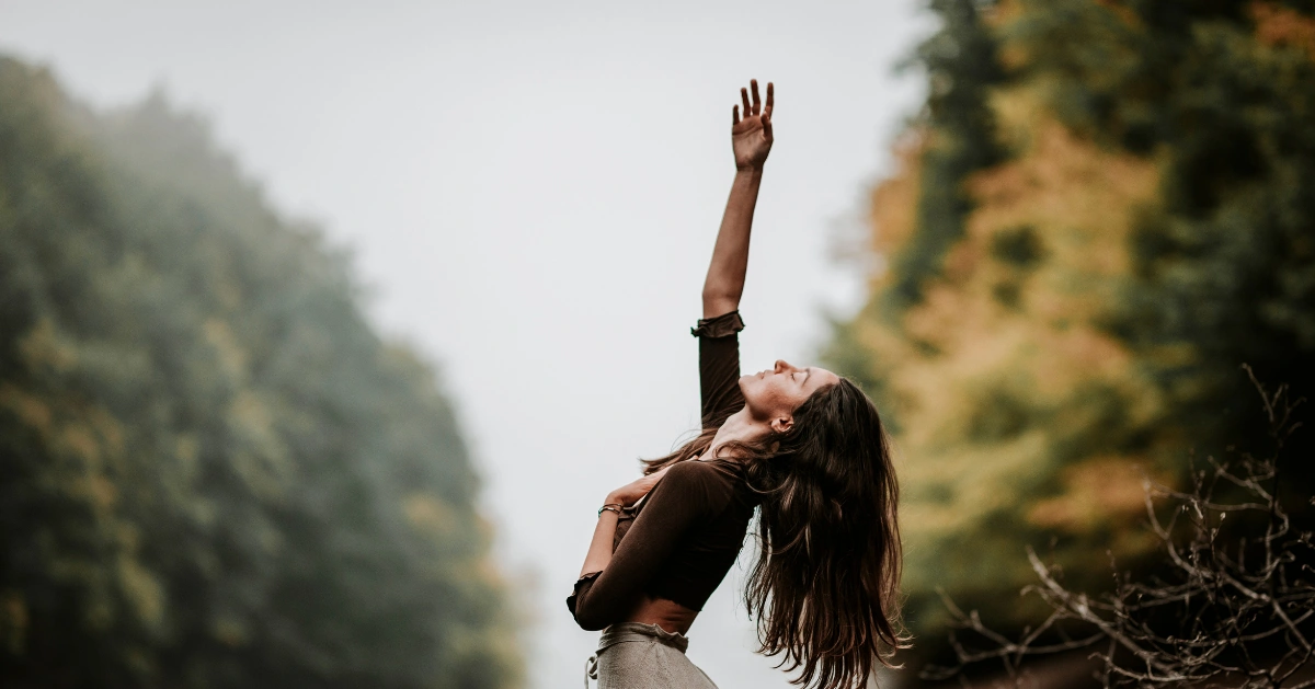 Girl reaching up to the sky