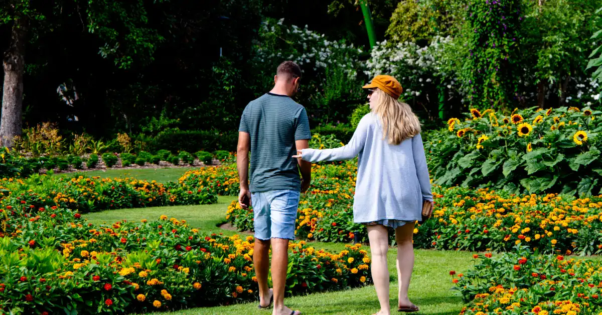 A couple walking through a flower garden