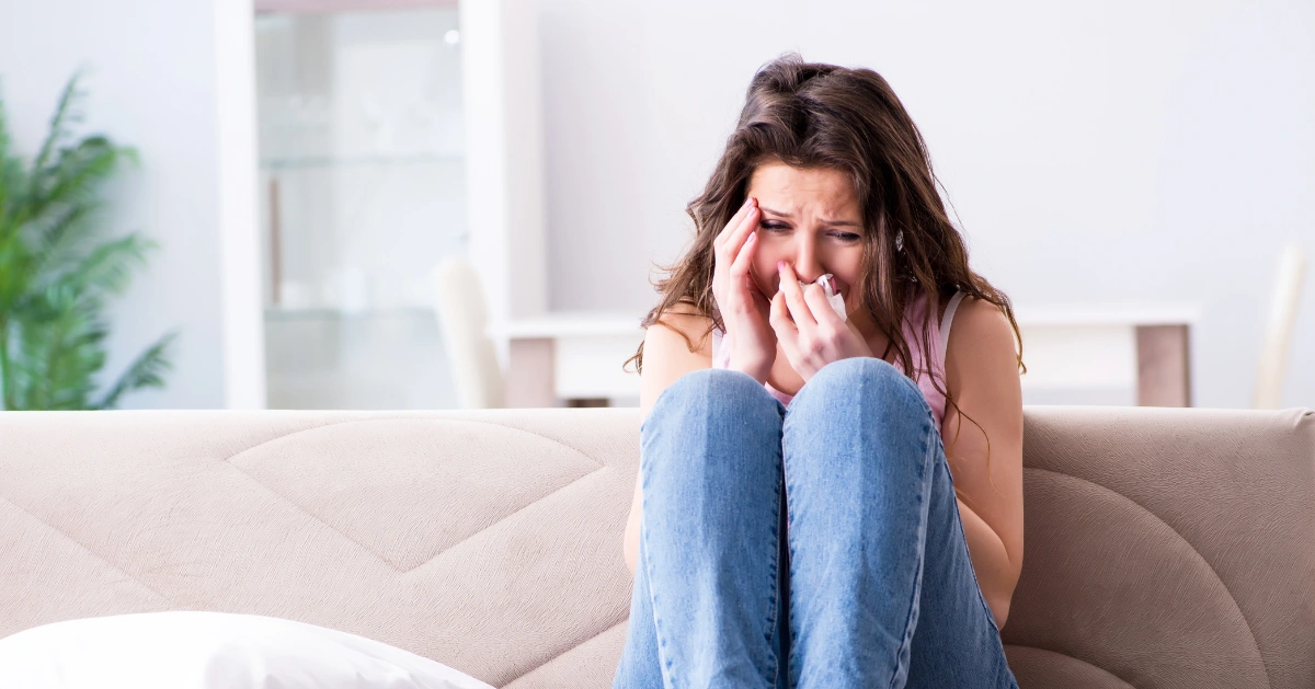 a girl crying on the couch