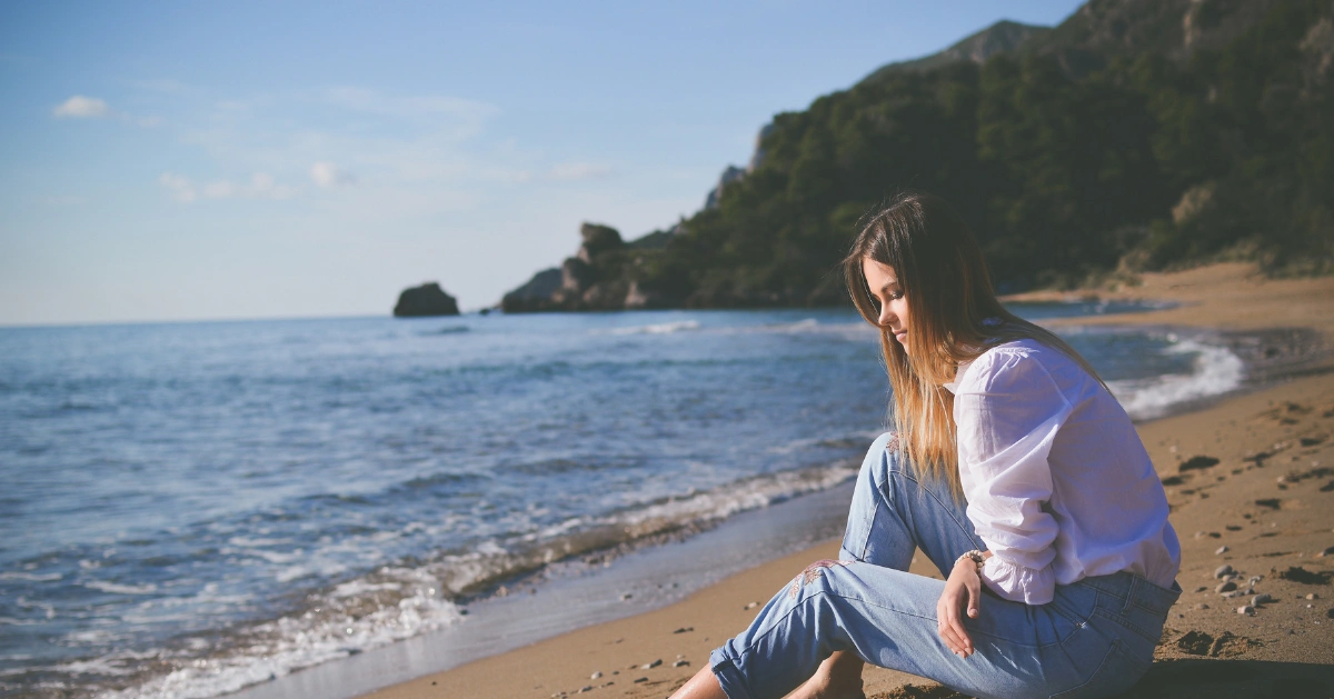 Girl sitting on the beach