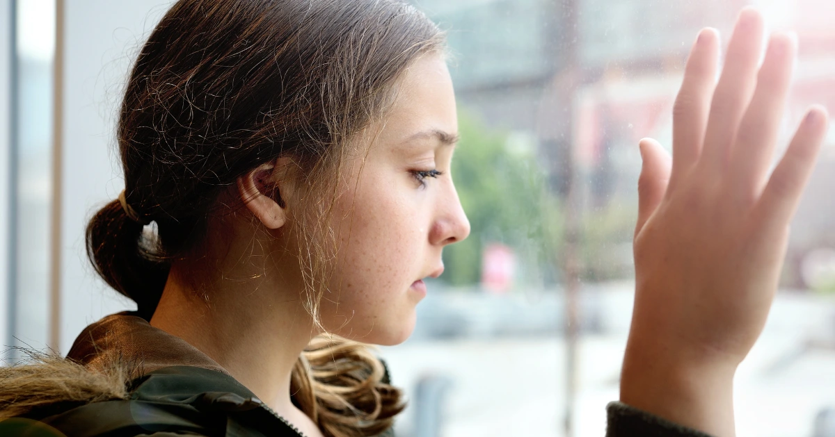 a girl looking out her window