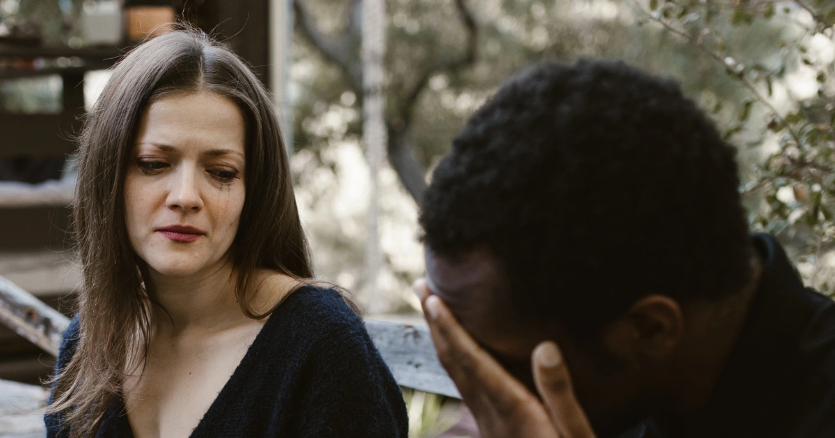 Girl crying near guy