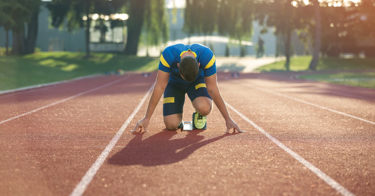 A young man getting ready to run track