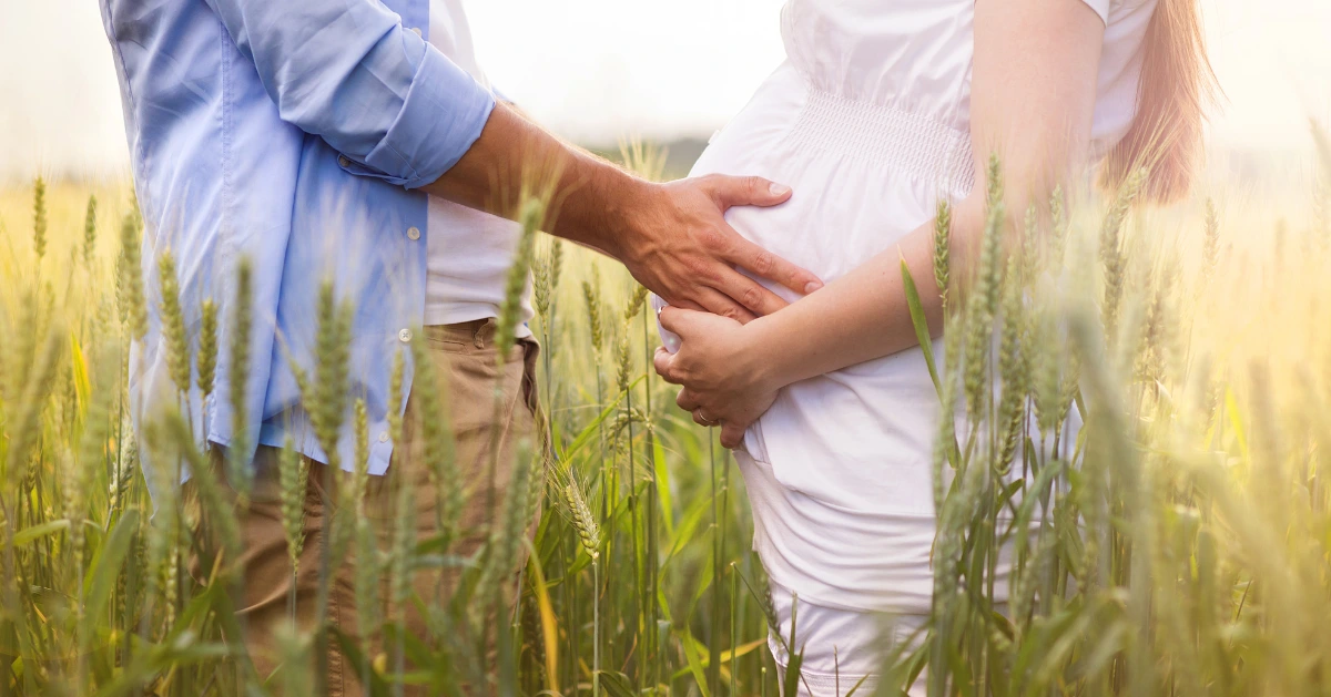 a man holding his partner's pregnant belly