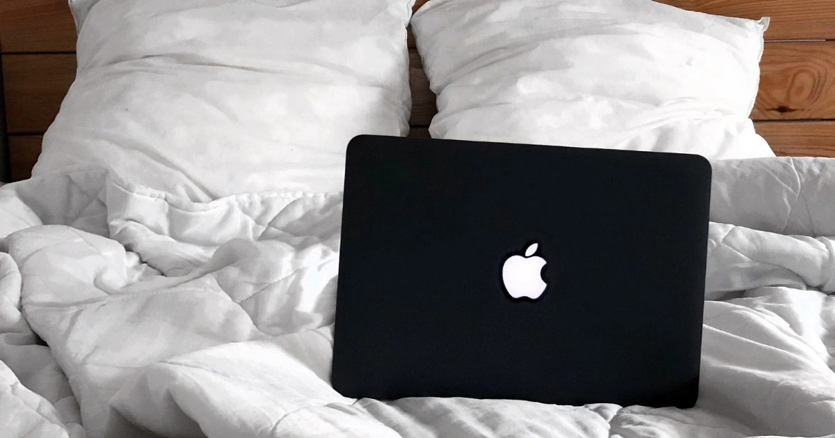 Laptop on a bed.
