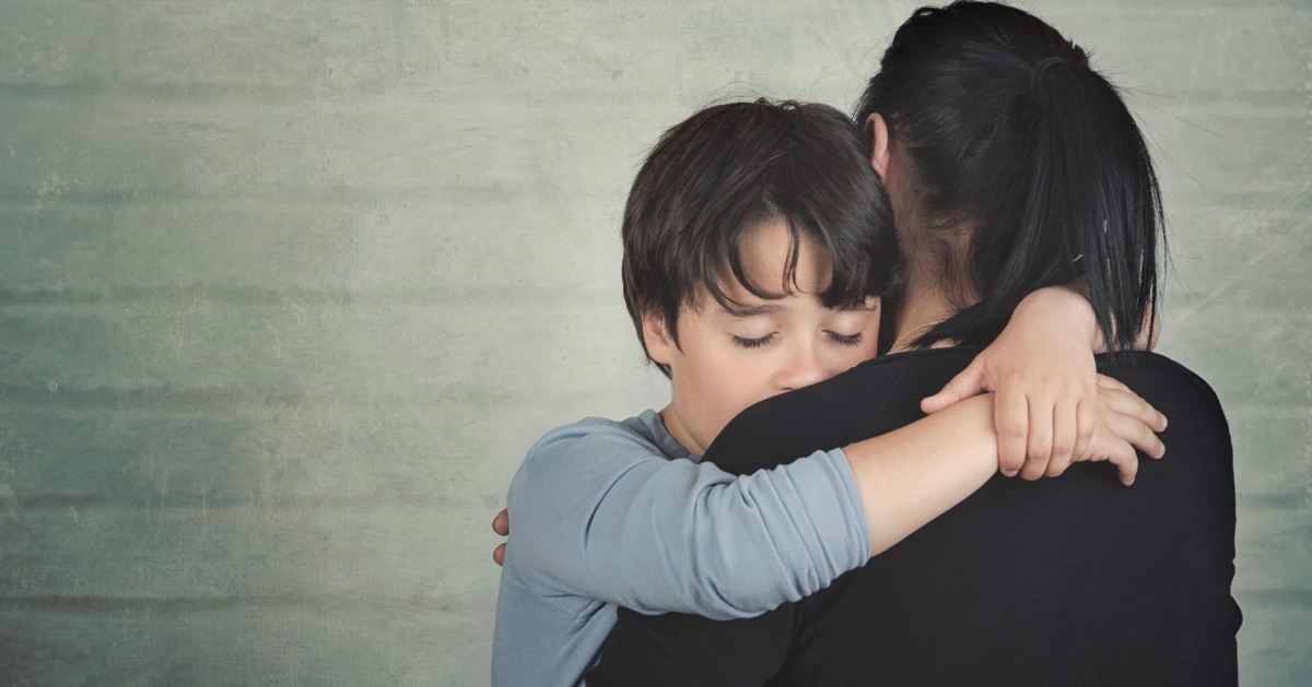 Little boy hugging a lady due to grief