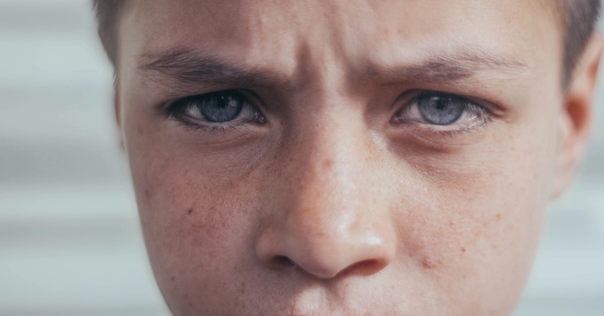 Close up of a man's sad blue eyes.