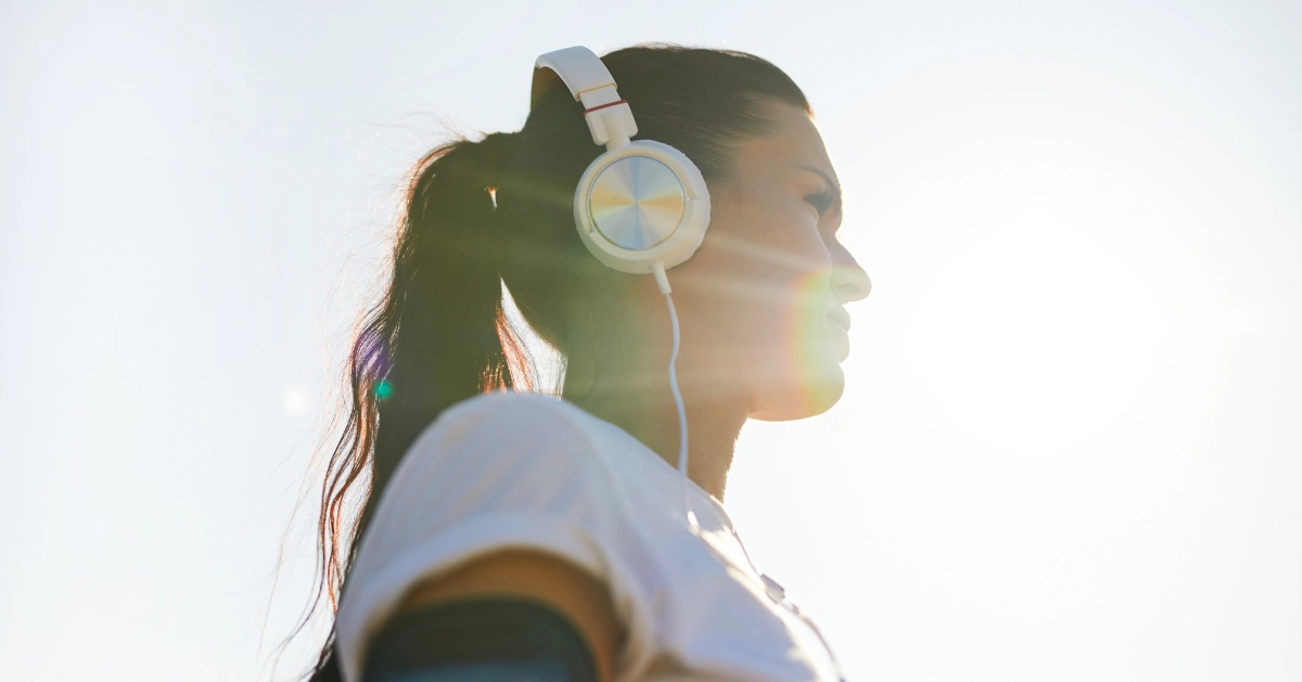 a girl listening to music with her headphone on
