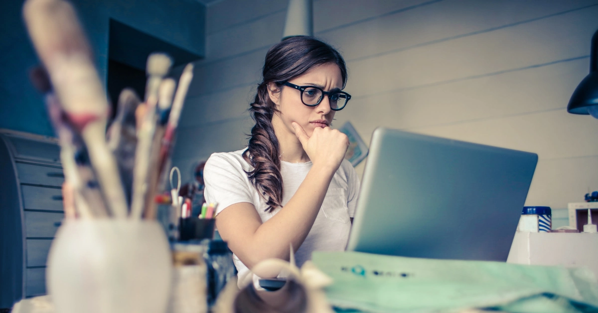Concerned woman looking at her laptop.
