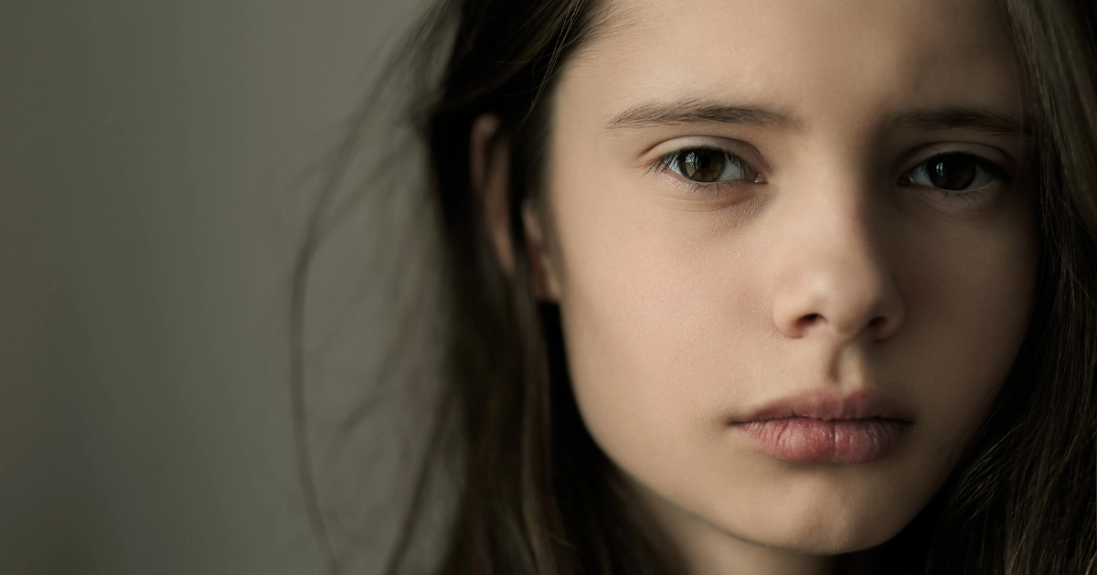 a girl looking at the camera sad