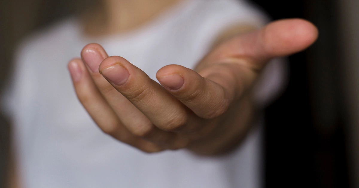 a hand reaching out to help someone