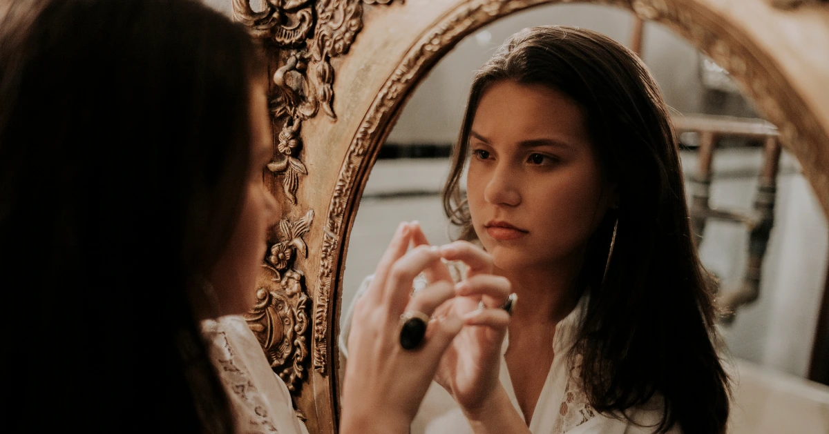 Girl looking in the mirro