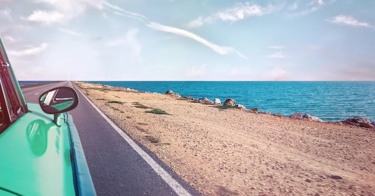 a car driving along the ocean road