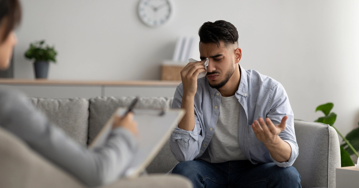 a guy crying in a counseling session