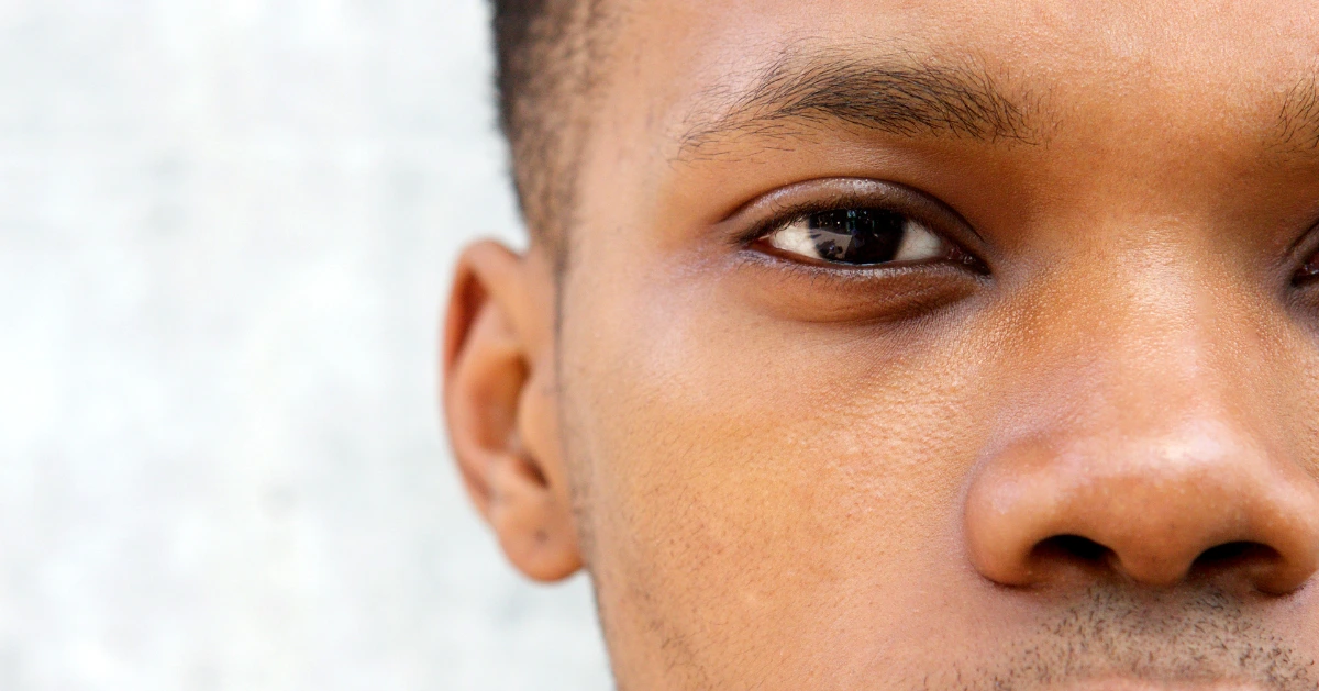half of a man's face looking at the camera