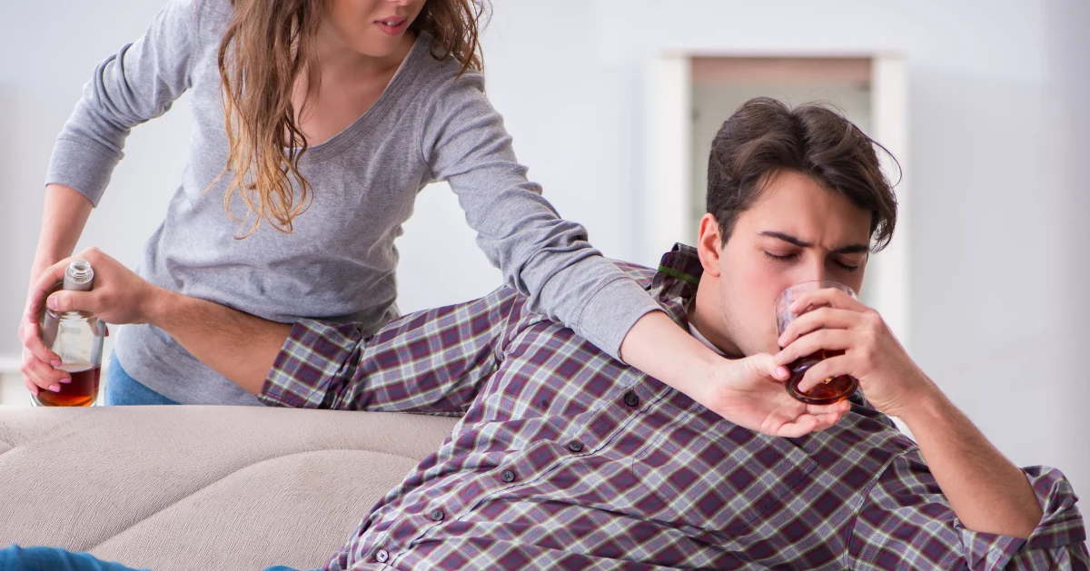 a sibling taking alcohol from their sibling