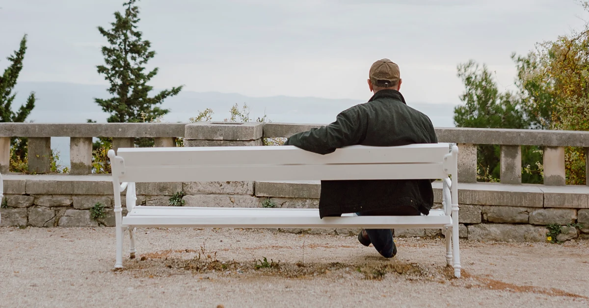 Guy sitting on bench alone