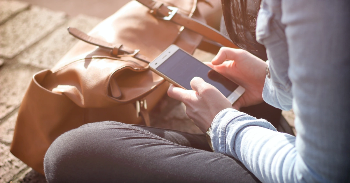 Woman holding her cell phone.