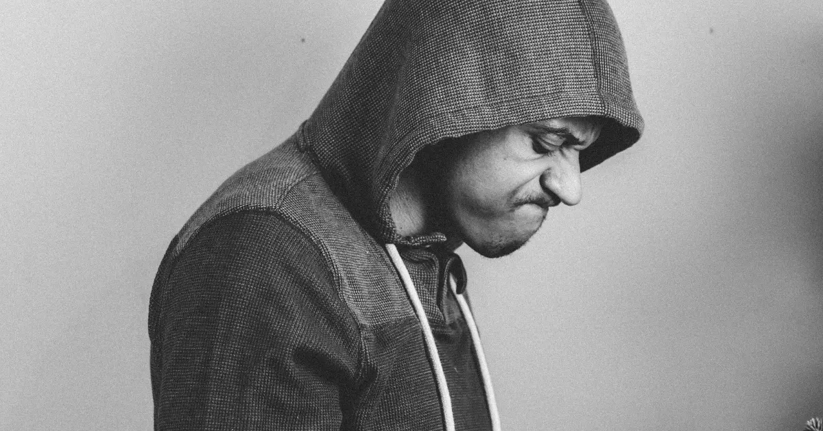 a guy wearing a hoodie with an angry face
