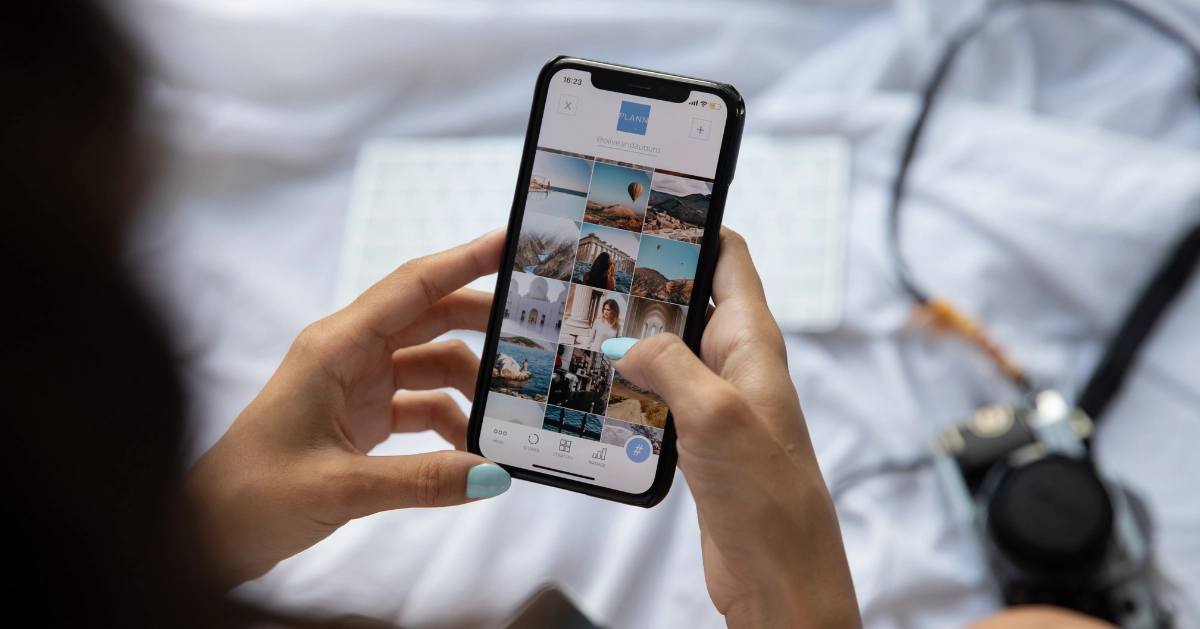 Girl sitting on bed scrolling Instagram