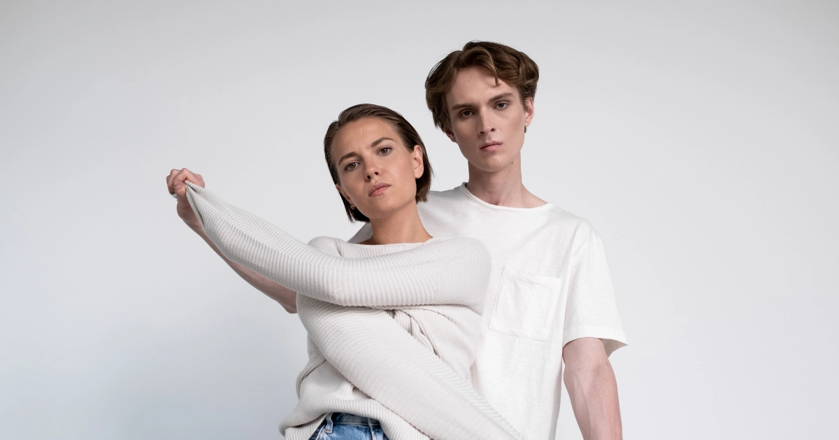 male and female standing together in white shirts