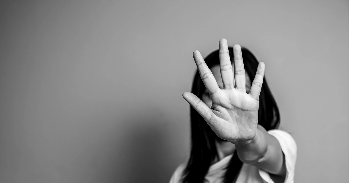 Girl hiding behind her hand wanting abuse to stop.