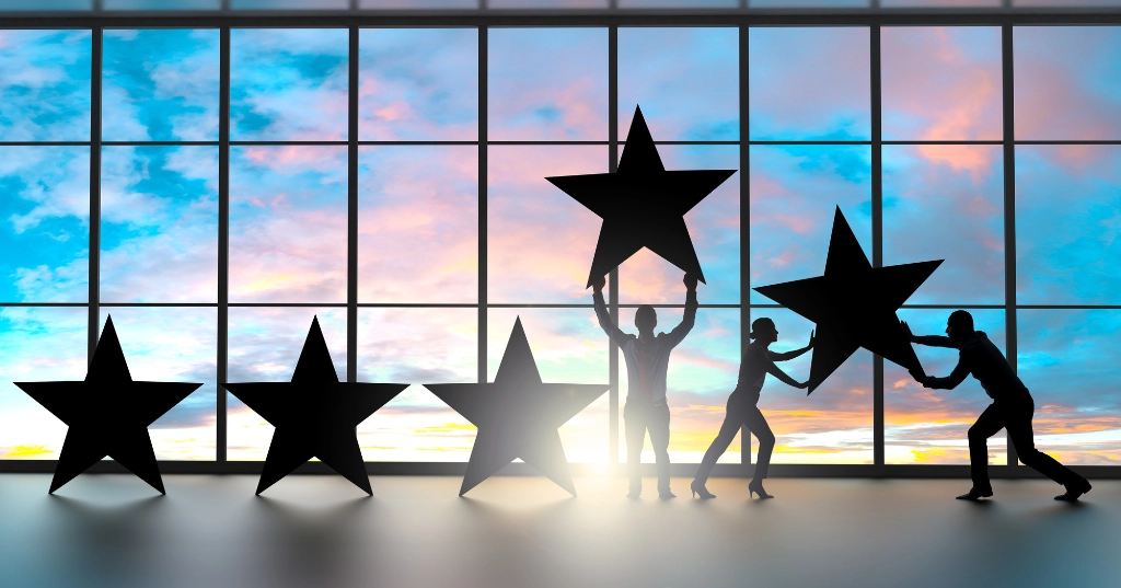 Group of people working together lifting up stars