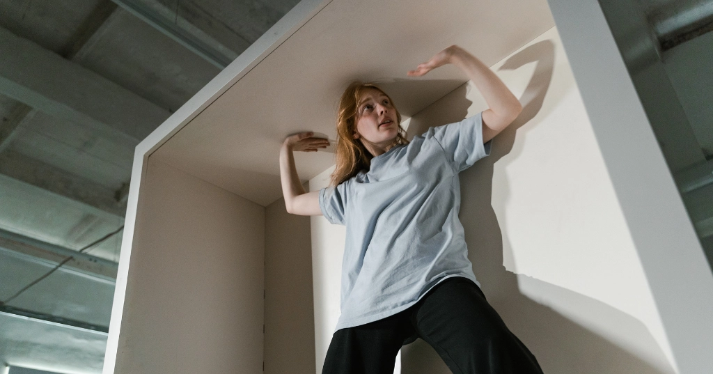 A Fearful Woman Having Claustrophobia in a Cabinet